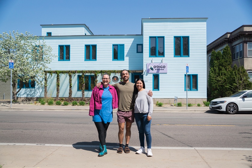 Three people standing outside of a building Three people standing outside of a building