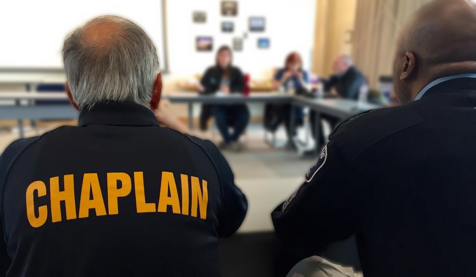 Police chaplain in a meeting.