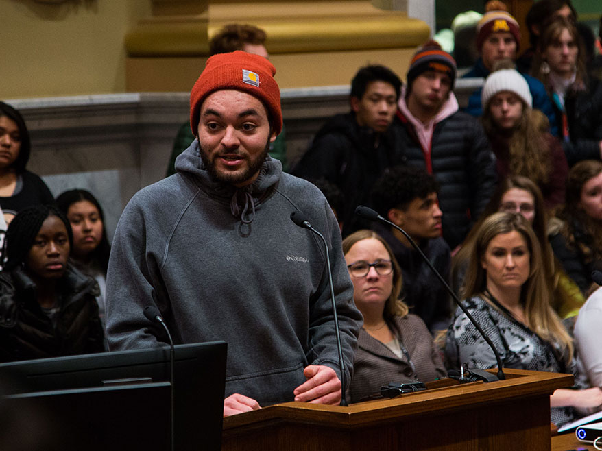 A young man addresses City Council at a public hearing.