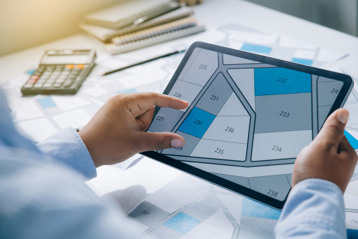 Hands of people pointing at and touching a screen with blueprints Hands of people pointing at and touching a screen with blueprints