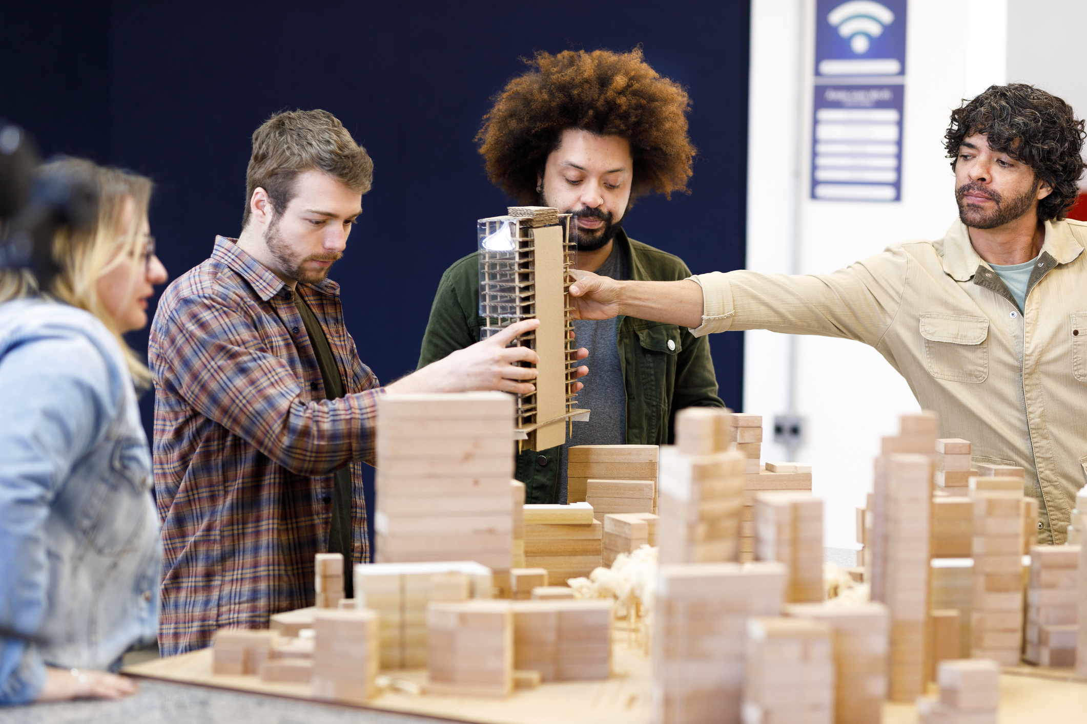 People looking a building model