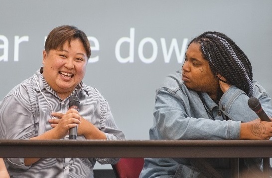 Two people talking on a panel