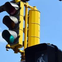 A traffic signal with the green light and walk sign illuminated