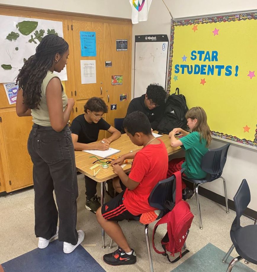 Students sitting at a desk in a classroom.