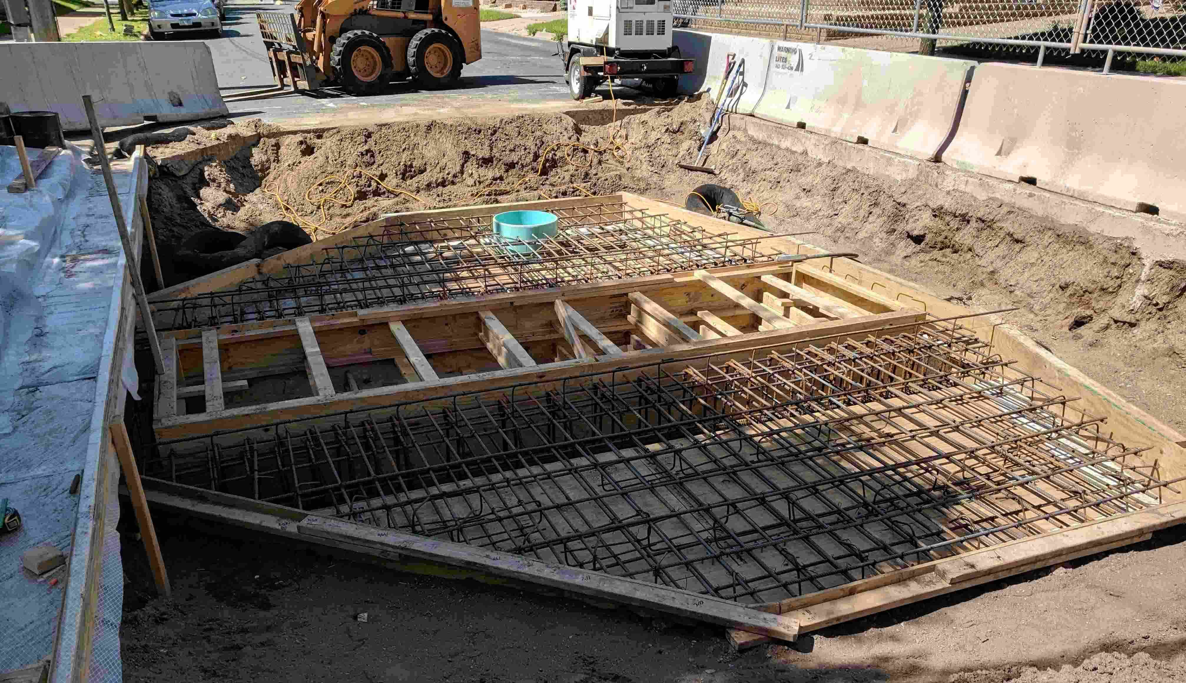 Underground concrete vault containing an isolation valve for a large-diameter drinking water transmission main in the process of being reconstructed. Pictured is the steel reinforcement prior to concrete placement. 