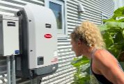 Woman looking at solar battery.