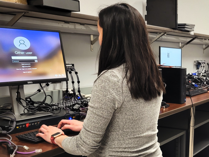 Employee logging into a desktop computer