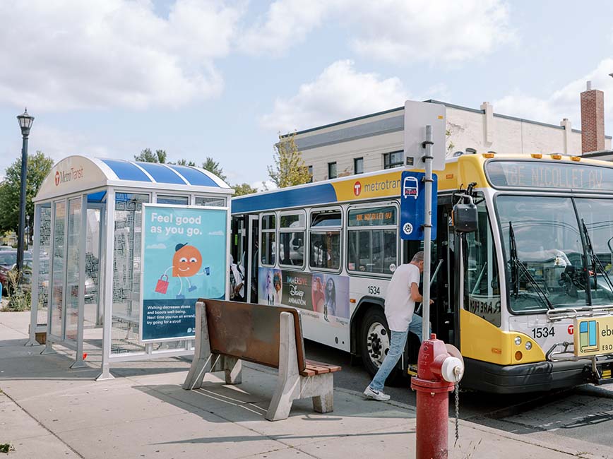 A person boards a bus at a bus stop in Minneapolis.