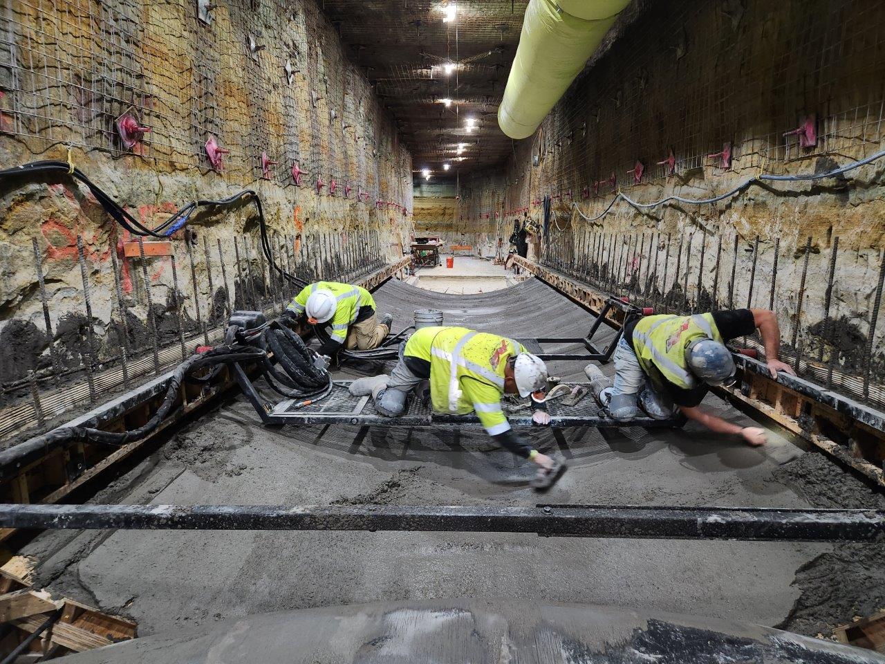 workers smooth poured concrete