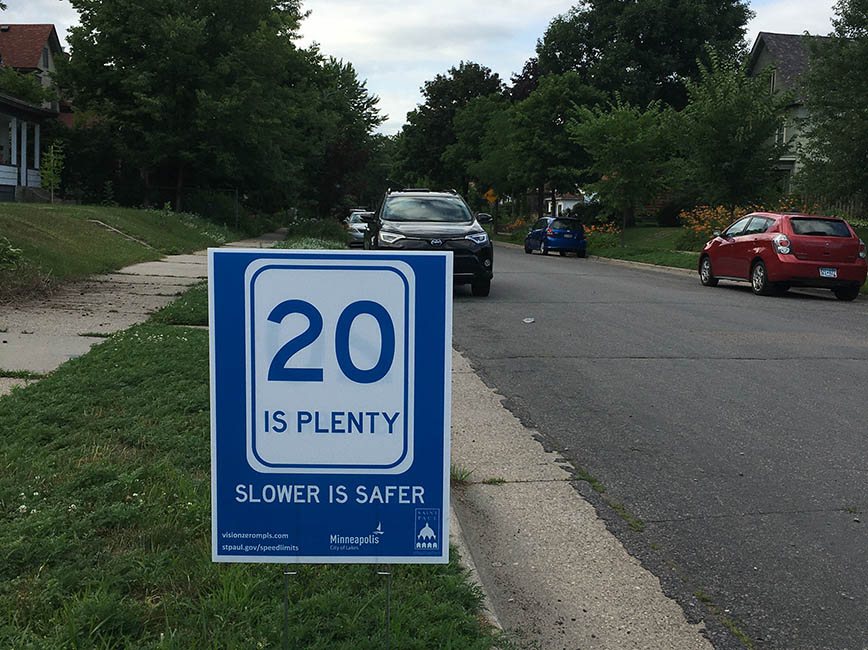 A yard sign that reads twenty is plenty, slower is safer