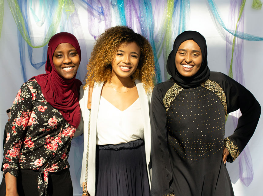 Three Scholars posing and smiling