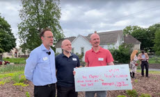 Three people receiving oversized check