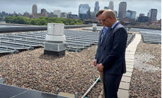 Two business people on roof of building with msolar panels