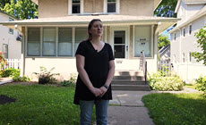 Minneapolis resident talking in front of home