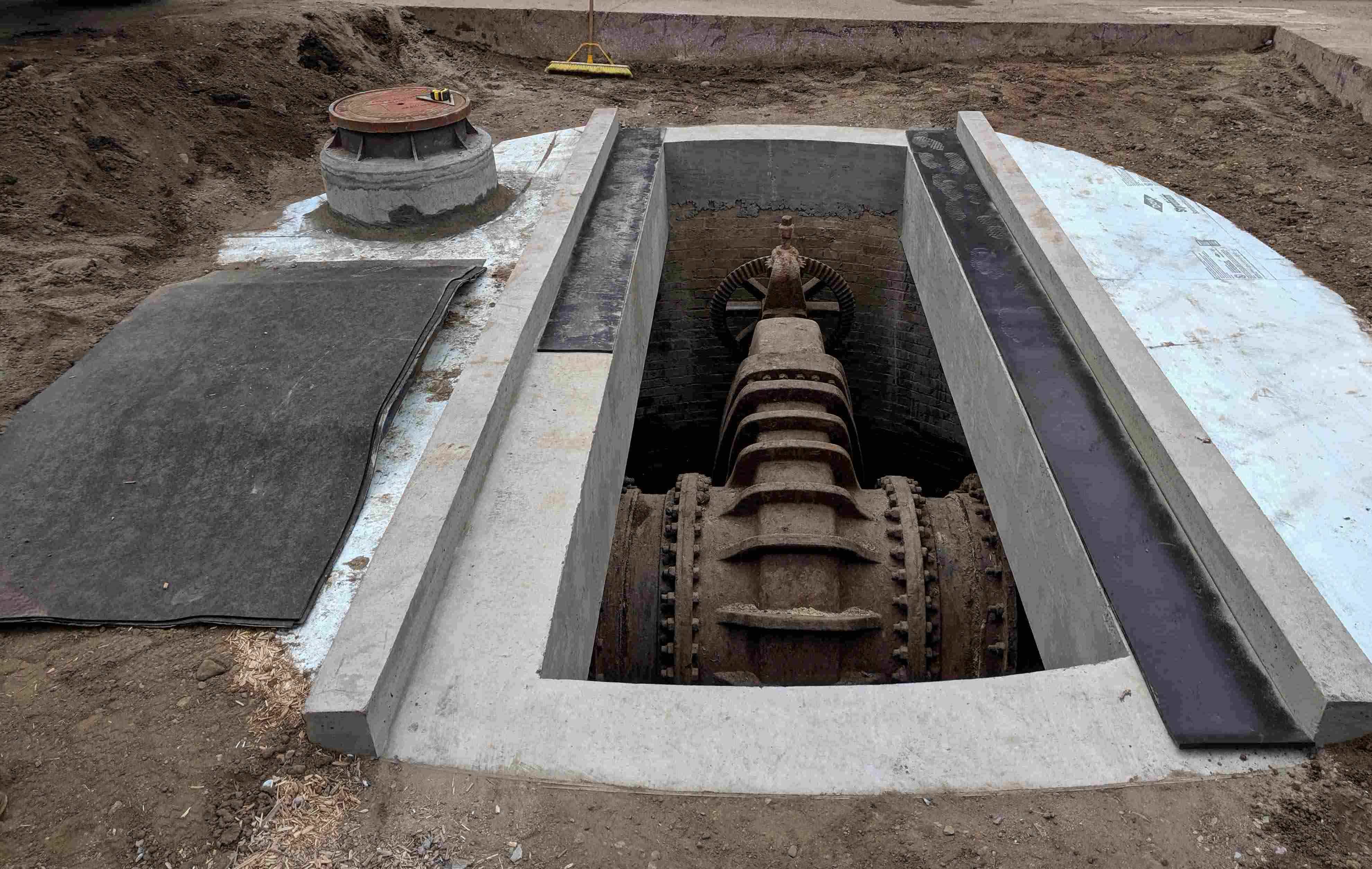 Vault under the street containing a valve for a drinking water main. 