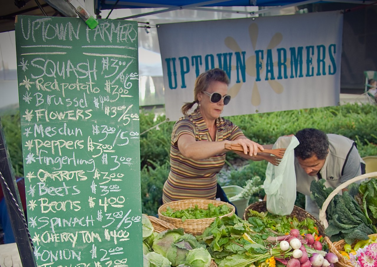 Farmers market vendor selling vegetables