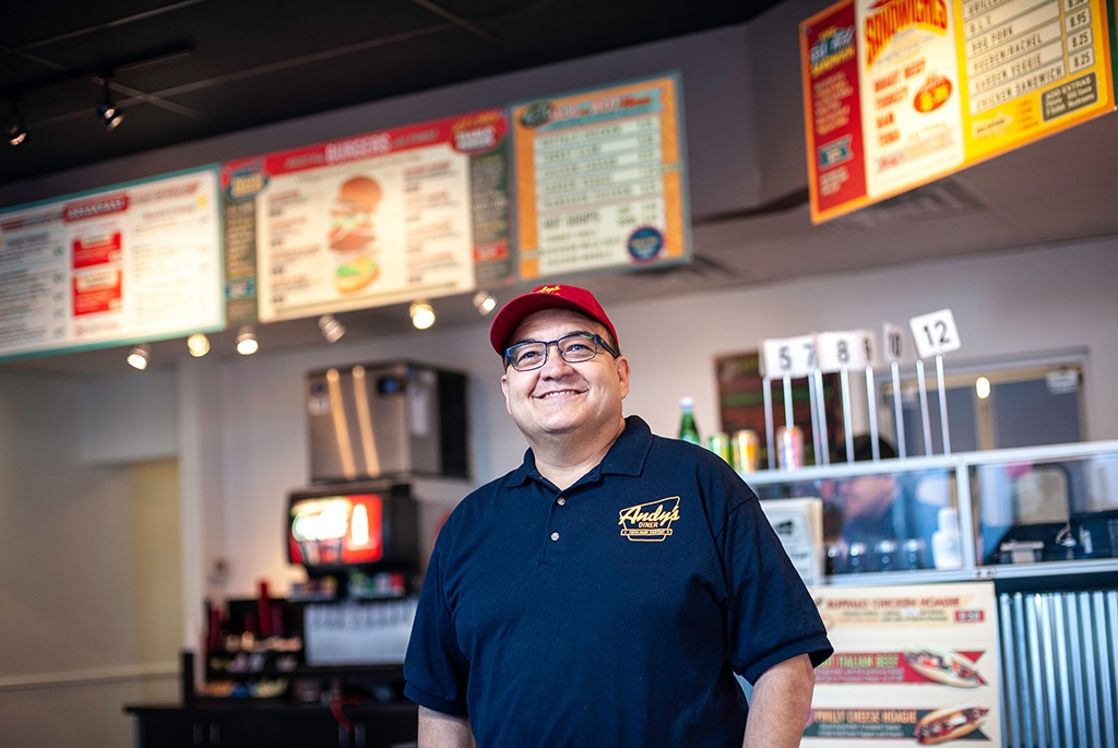 Person standing in front of a food service area