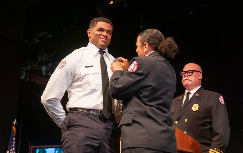 A firefighter graduates from the Minneapolis Fire Academy A firefighter graduates from the Minneapolis Fire Academy