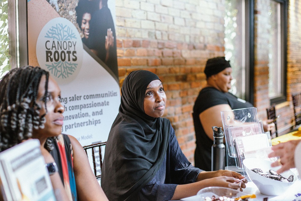 People sitting behind a table