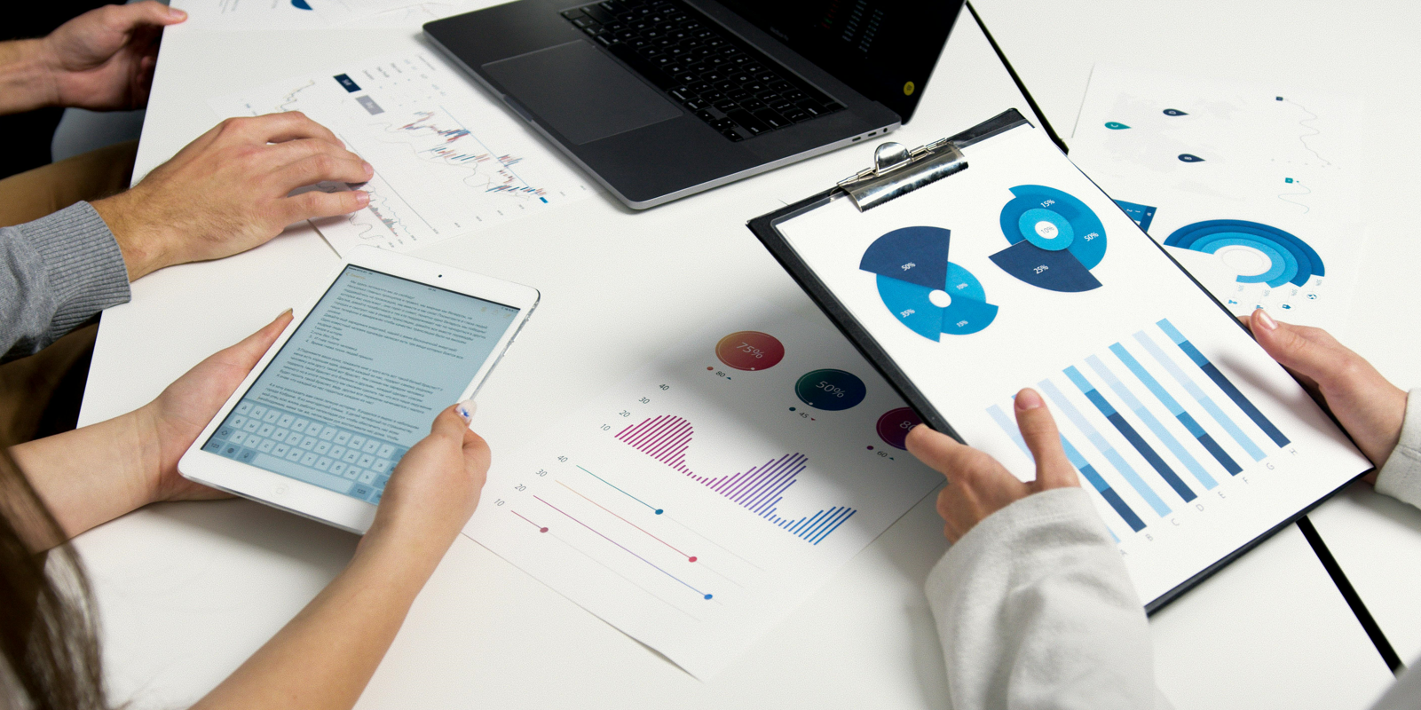 Charts and data on paper and tablet