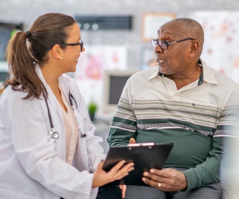 Doctor and senior patient talking and smiling