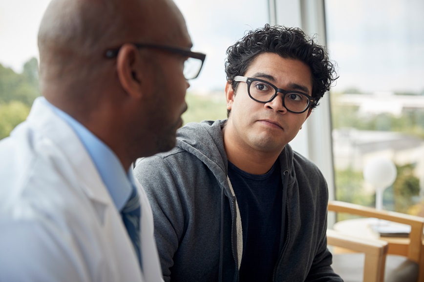 Doctor talking with teenager