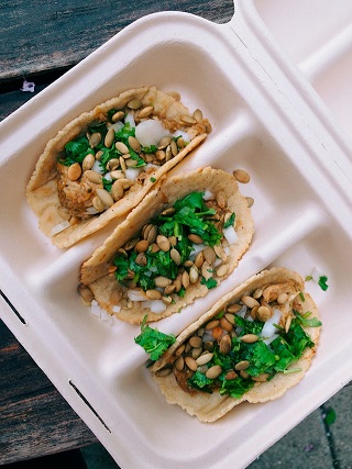 To-go box with tacos in it