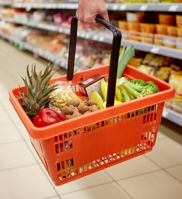 Hand holding grocery basket