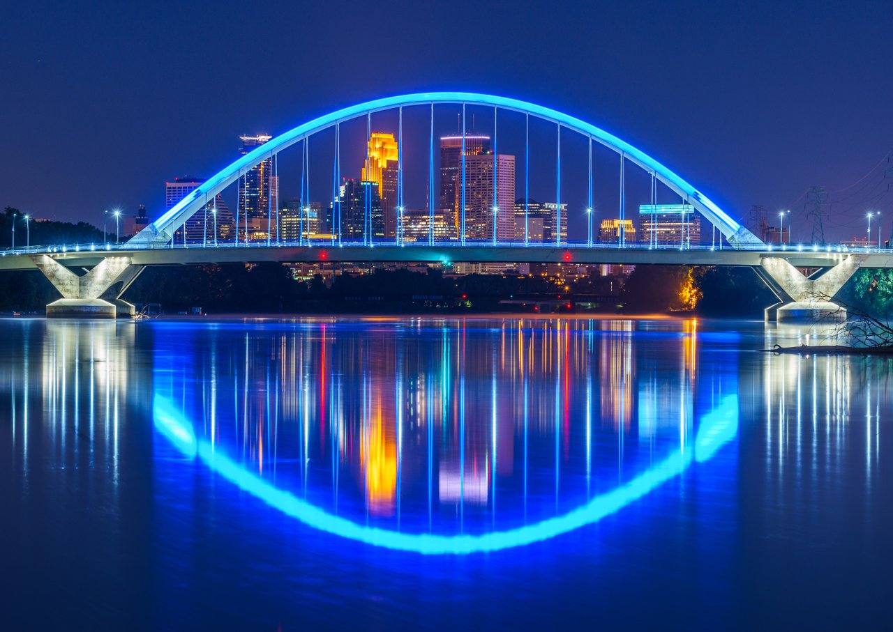 Looking through the Lowry Ave. Bridge to downtown Minneapolis at night; Photo by Lane Pelovsky, Courtesy Meet Minneapolis Looking through the Lowry Ave. Bridge to downtown Minneapolis at night; Photo by Lane Pelovsky, Courtesy Meet Minneapolis