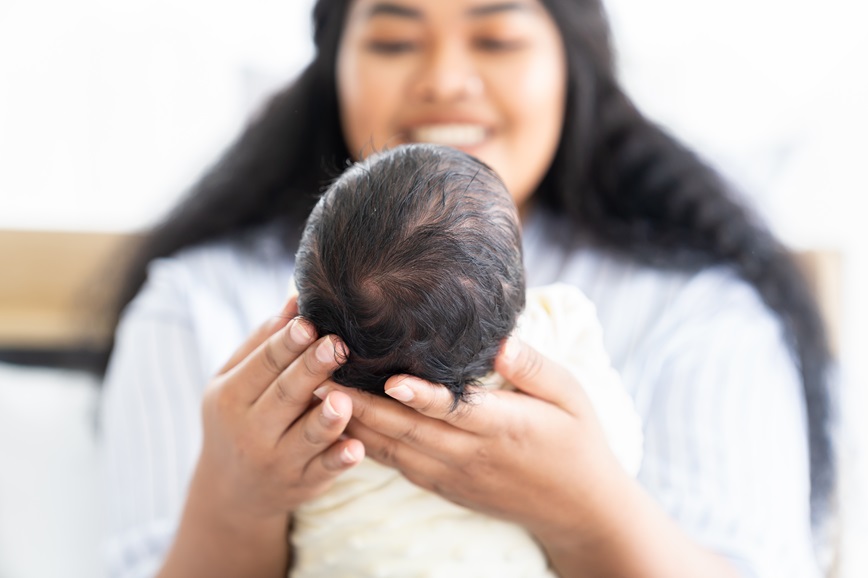 Smiling mother holding infant