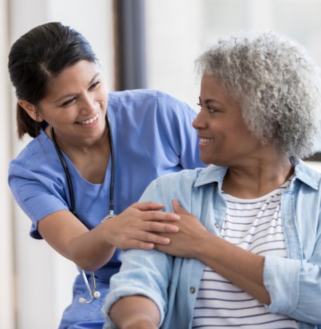 Nurse and older patient smiling together