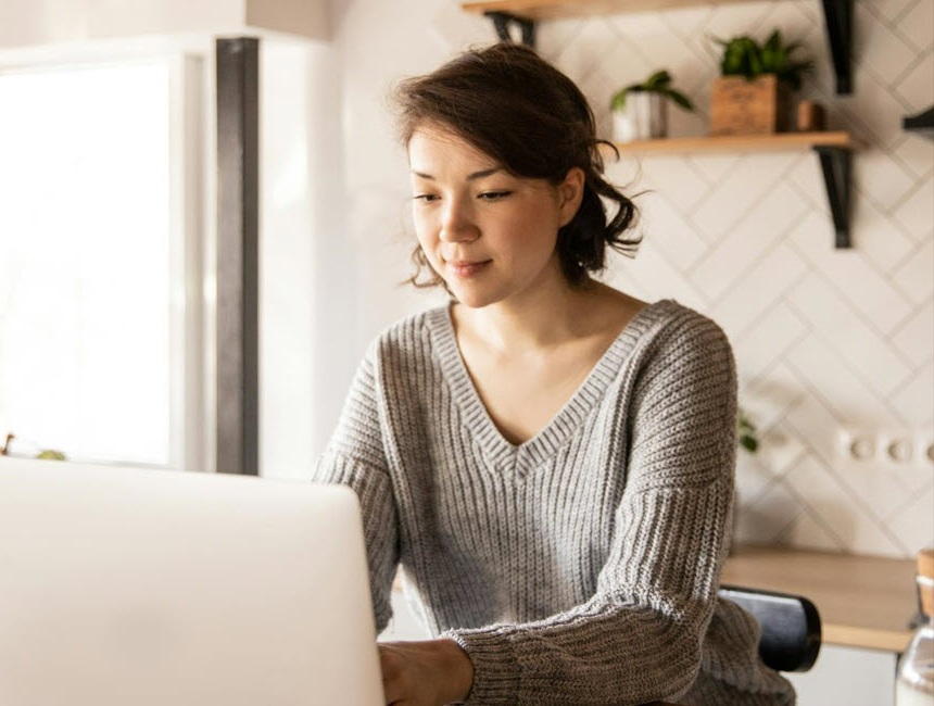 Person at laptop in their home