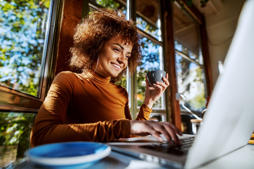 Person looking at laptop smiling