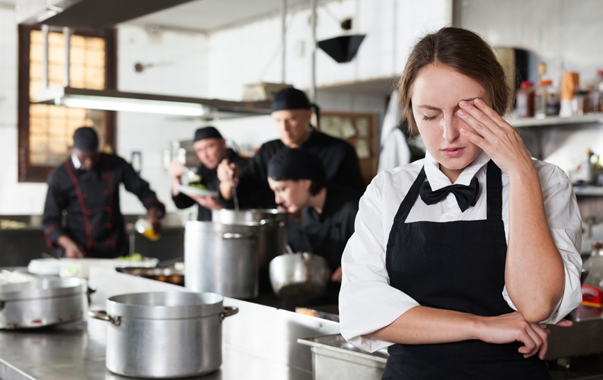 Restaurant employee with hand to head