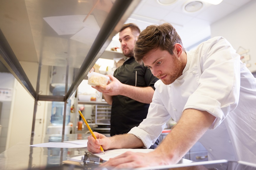 Restaurant employee looking at document