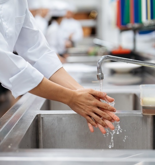 Restaurant worker washing hands