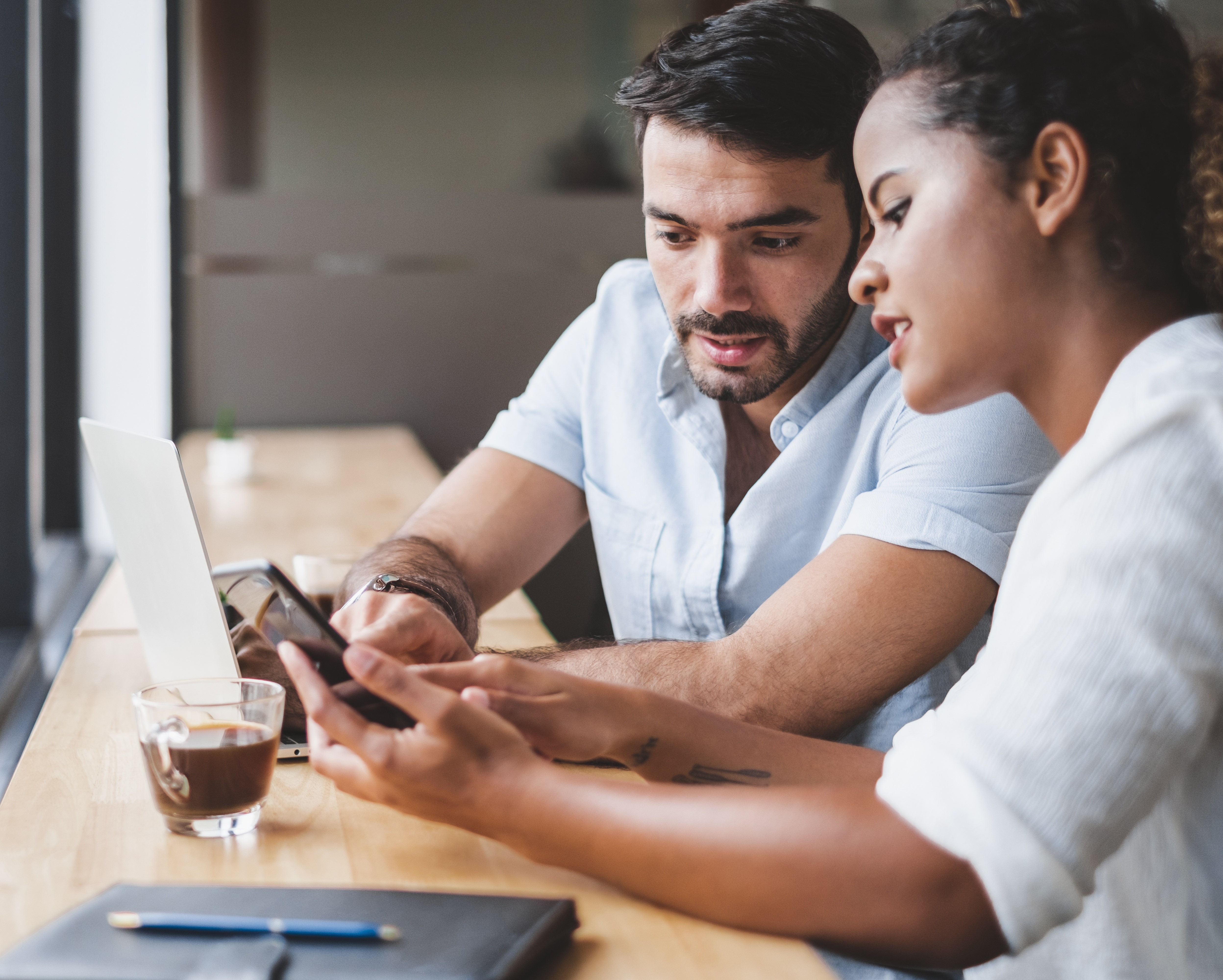 Two people looking at phone