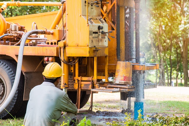 person drilling a well