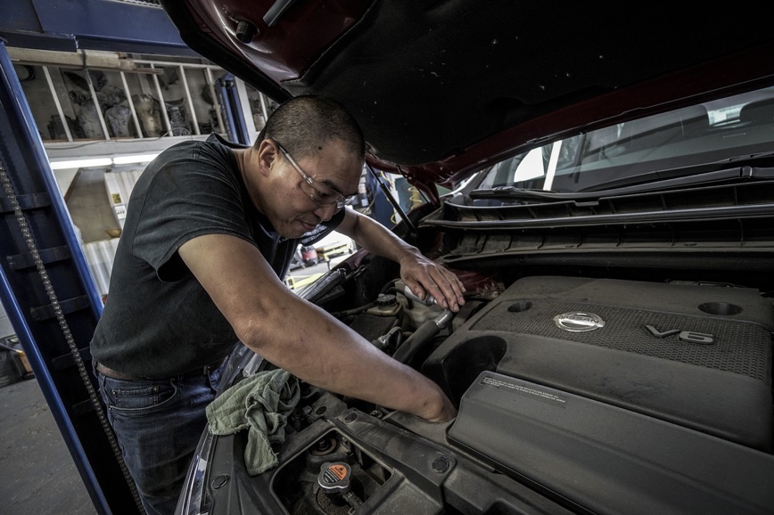 Person working on an auto engine