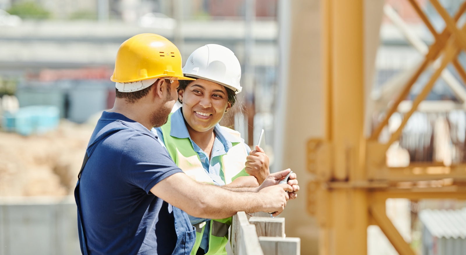 Two construction workers talking at building sie