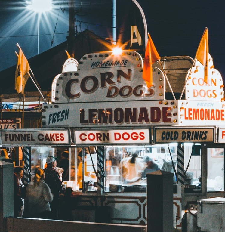 Corn dog stand at public event at night