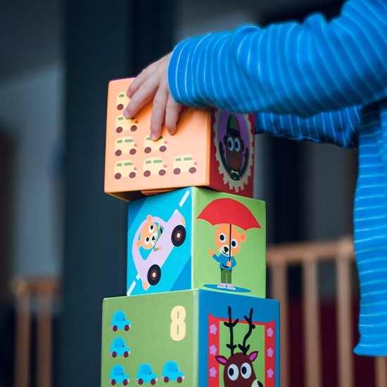 Toddler stacking colorful blocks