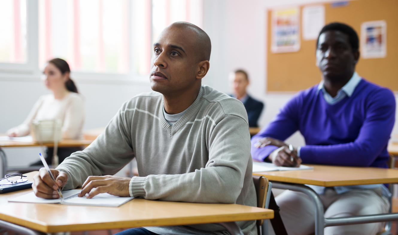 Adult-latino-focused-on-lesson