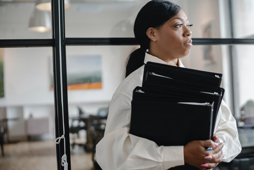 Business person holding binders