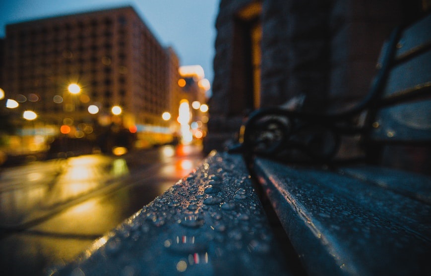 Wet bench on city street at night