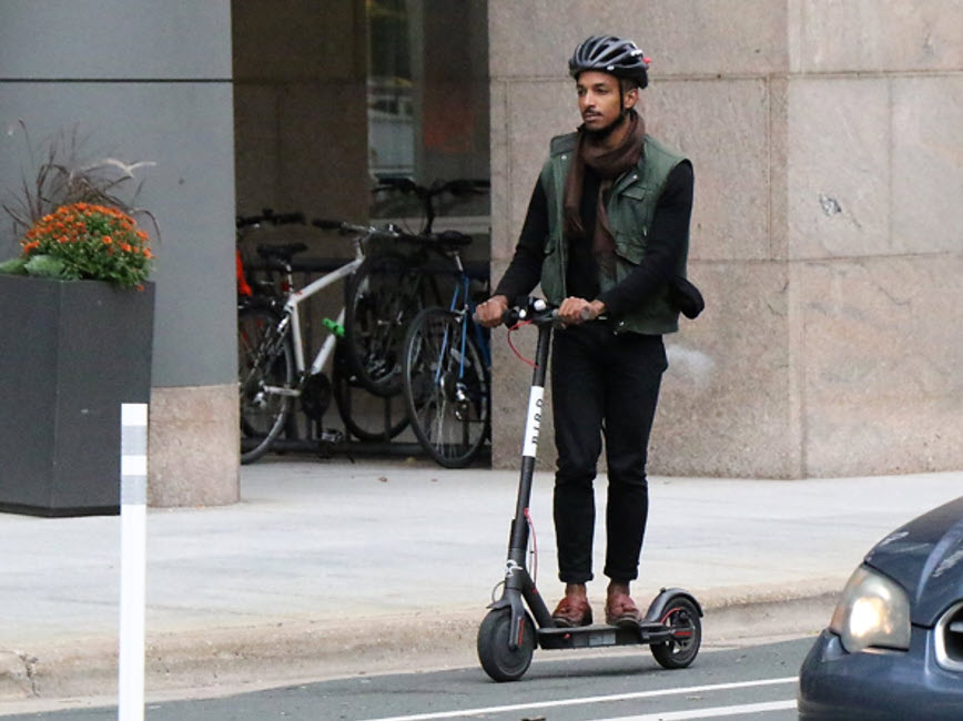 Riding scooter on street Riding scooter on street