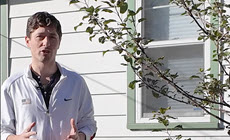 Mayor Jacob Frey speaking in front of house